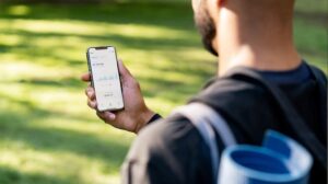 Yoga instructor looking at income summary on his phone