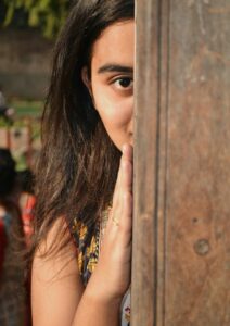 Personas Young Woman Hiding Behind Post