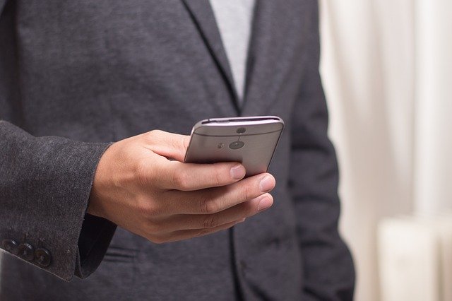 Businessperson Doing Something on a Mobile Phone