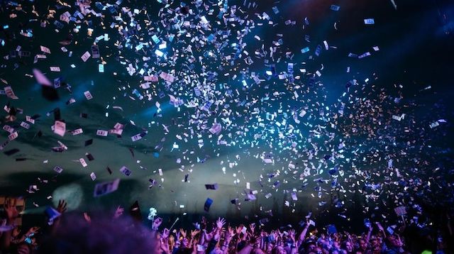 Crowd of People Throwing Paper in the Air