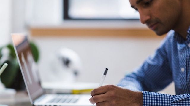 Freelance Writing Man Writing at Desk