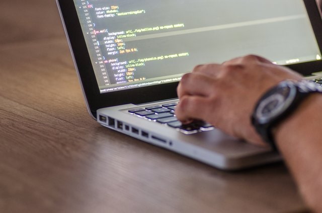 Person coding on a laptop computer