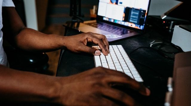 Person Working on Computer at Desk