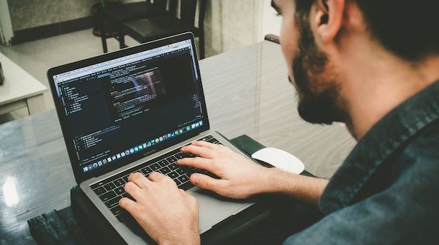 Reverse Engineering Man Working at Computer Keyboard