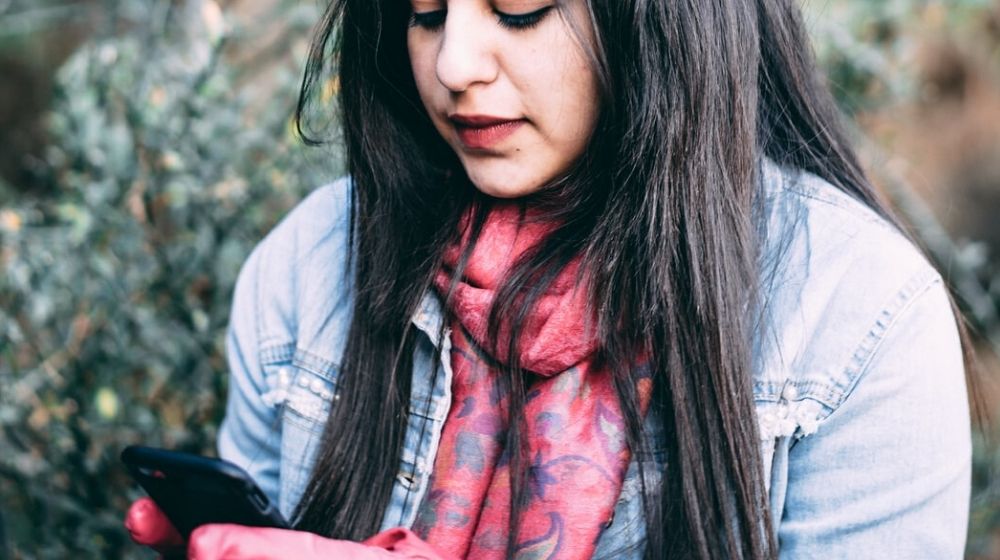 Woman Reading Something on Her Phone