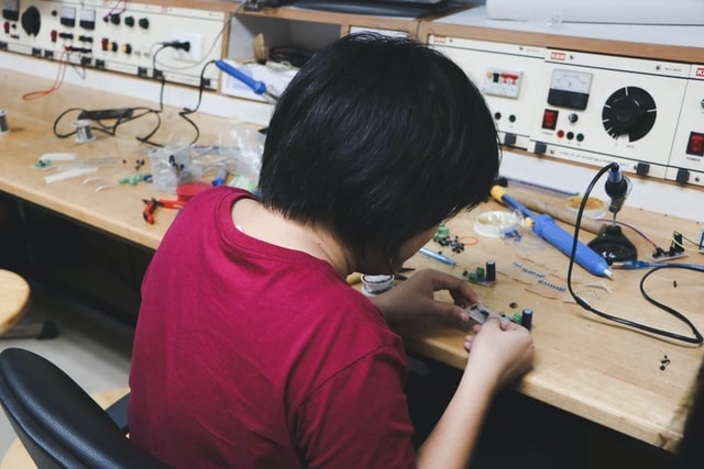 Woman Working on Electronic Assembly