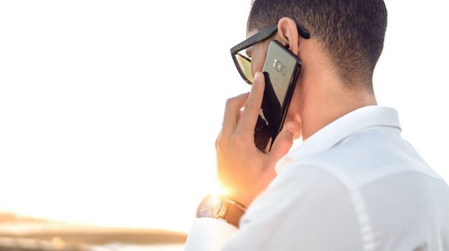 Work from Home Policy Man Talking on Smartphone