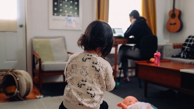 Work from Home Policy Woman Working in Room with Child