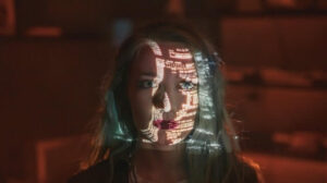 Female developer with code projected on her face