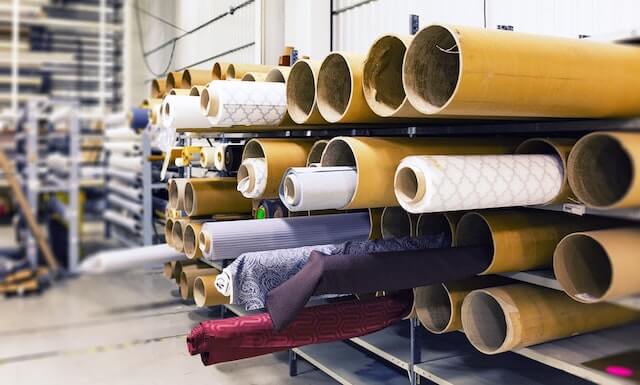 Manufacturing warehouse filled with rolls of fabric