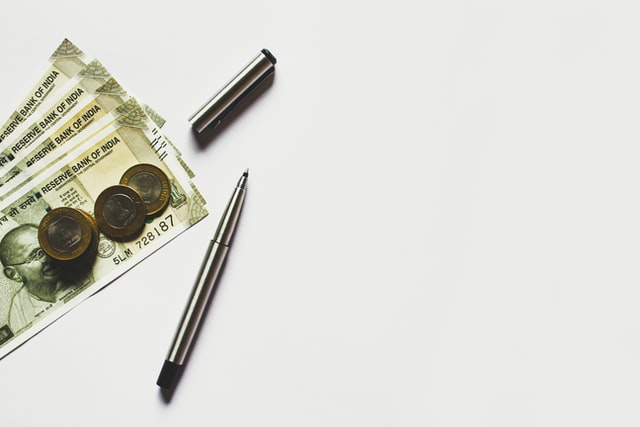 Bills and coins on a table