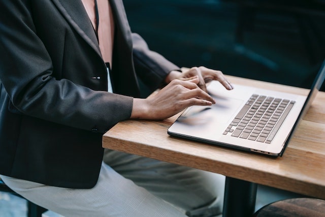 Business professional typing on a laptop