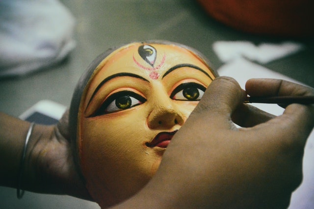 Close-up of artisan painting a mask