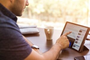 Man reading article on table in cafe