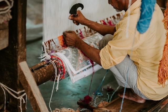 Man weaving a rug