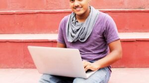 Man working on laptop outdoors