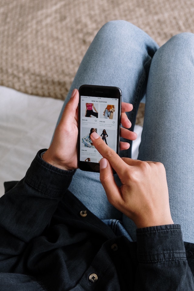 Person scrolling through online products on smartphone