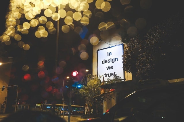 Photo showing a signboard reading &quot;In design we trust&quot;