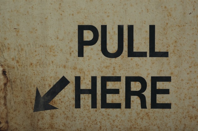 Pull here sign painted on a wall