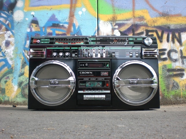 Retro boombox sitting in front of graffiti wall