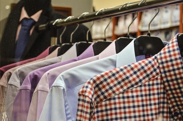 Row of men’s shirts on hangers in a shop