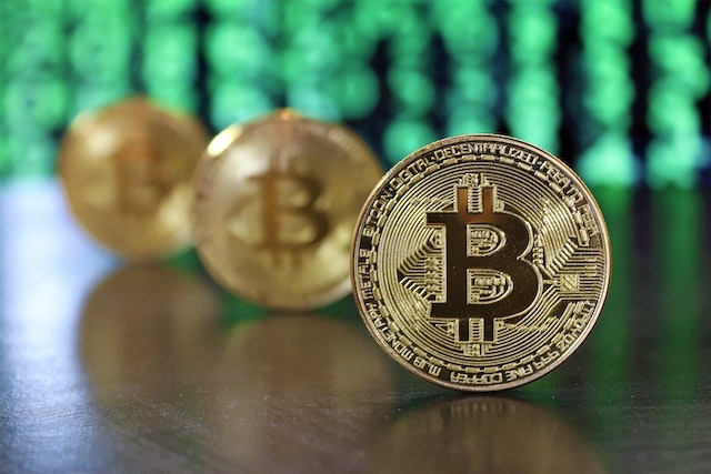 Three bitcoins standing upright on table