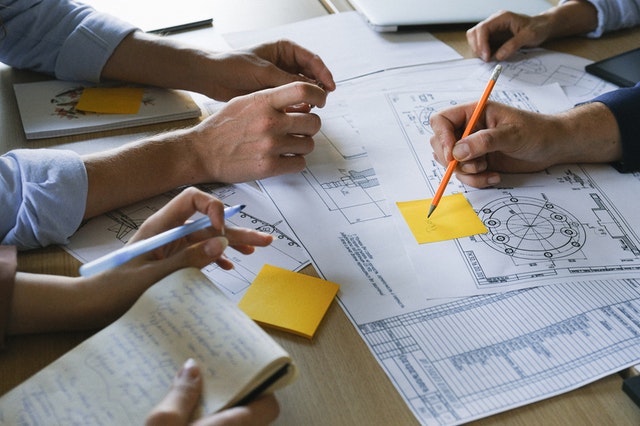 Three people working together at a desk