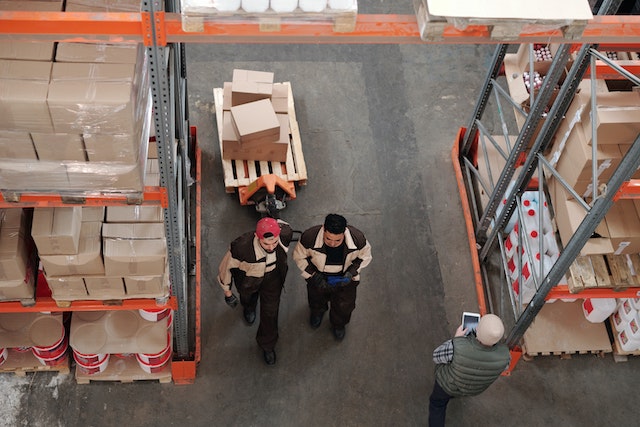 Two men walking side by side in a warehouse