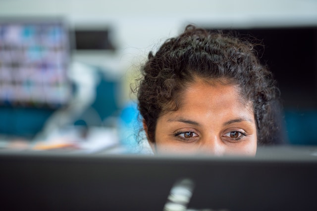 Woman seen from behind her desk