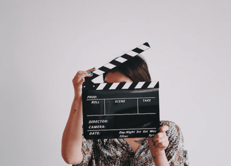 Woman with film clapperboard