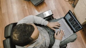 Overhead view of a beauty salon owner at a laptop