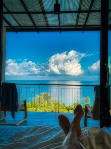 Photo of a balcony and water beyond shot from bed