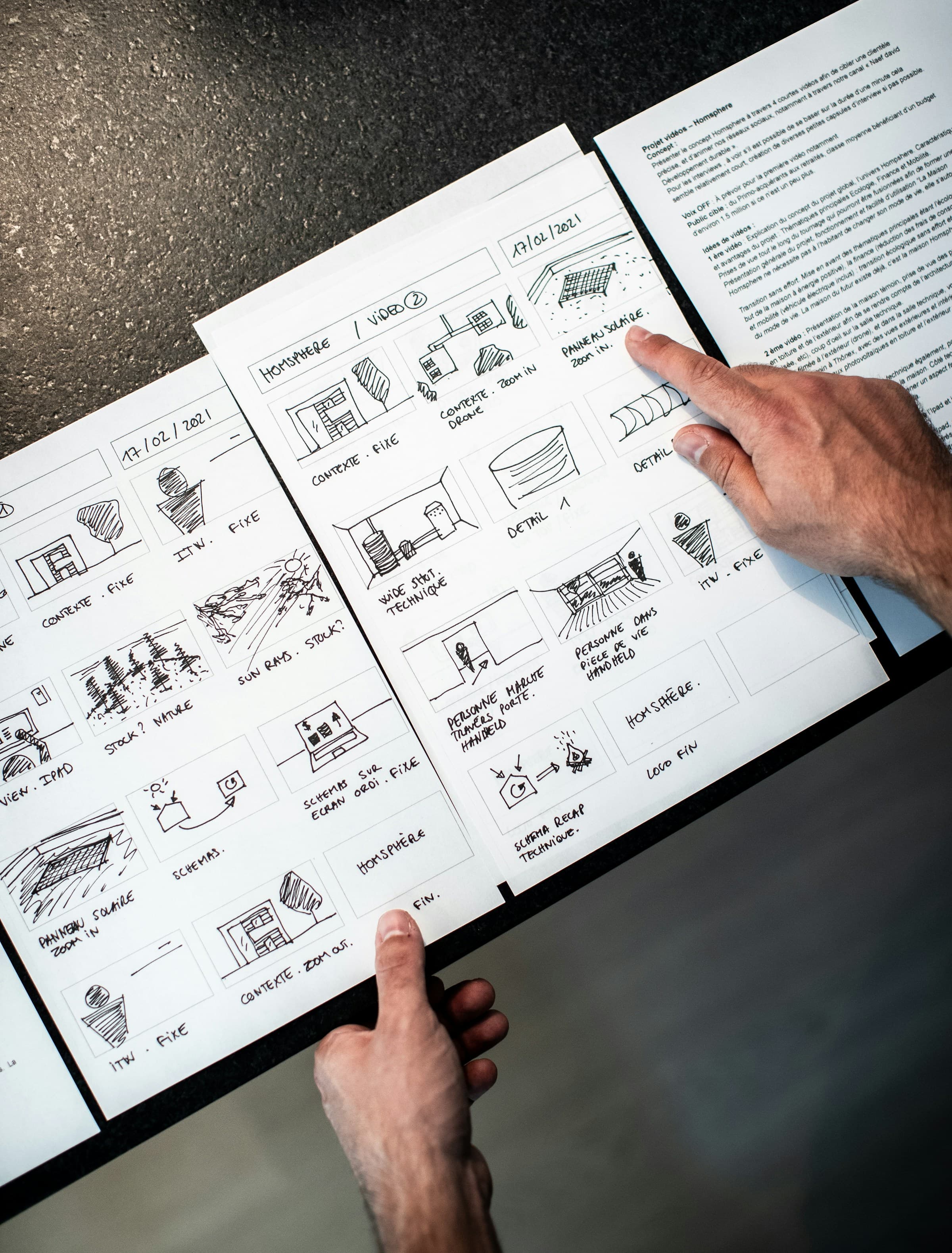 Person with a storyboard that maps out a video