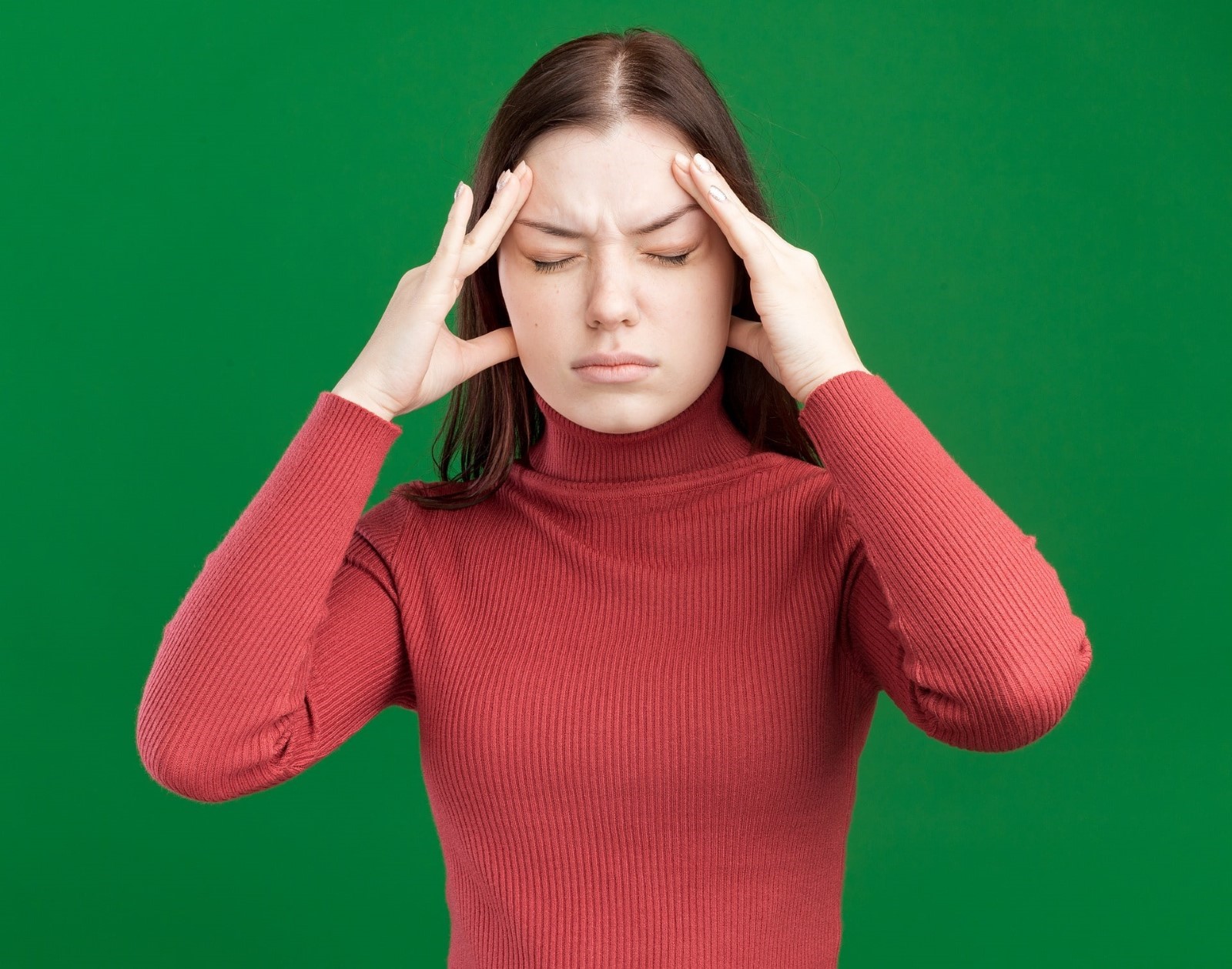 Stressed woman holding her head in her hands