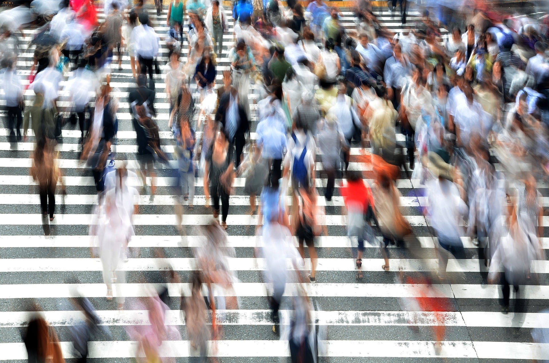 Time lapse photo of pedestrians crossing a street