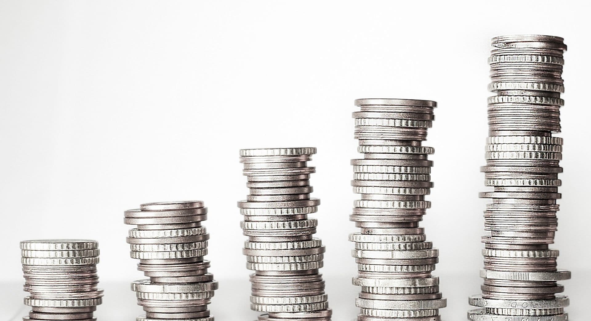 Three stacks of silver coins