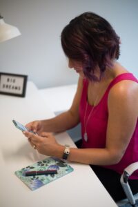 Woman in pink shirt ordering something on her phone