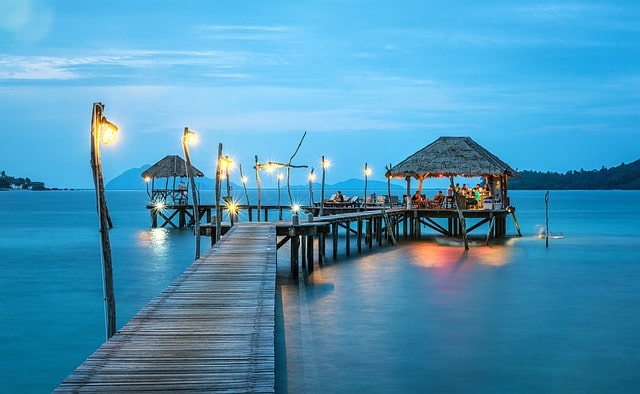 Wooden pier leading to a restaurant on water