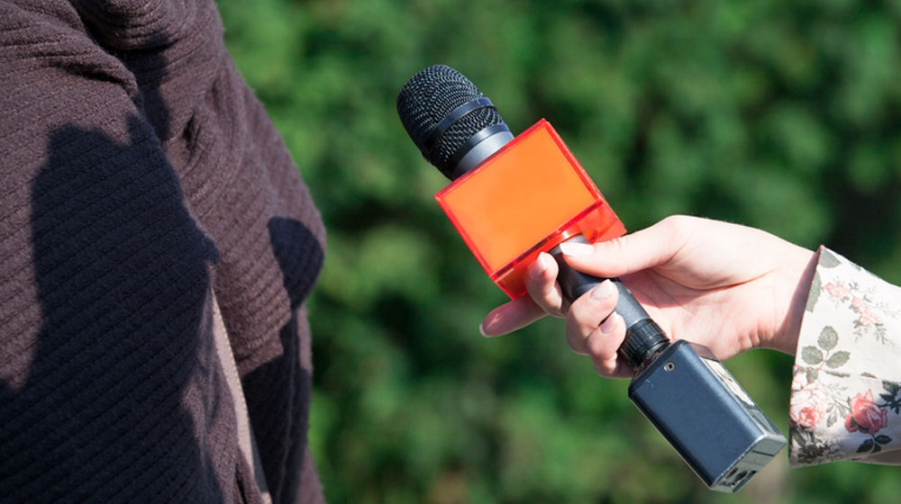 holding microphone for interview to represent ways to get PR for your small business