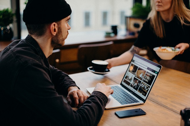 Man using laptop at cafe