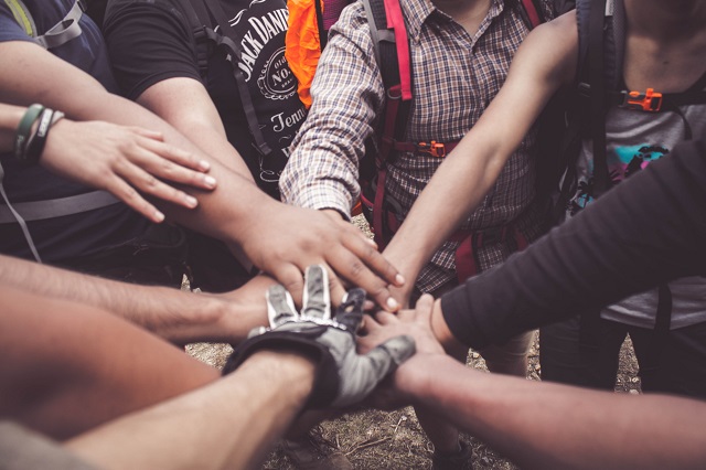 Group Of People In A Huddle