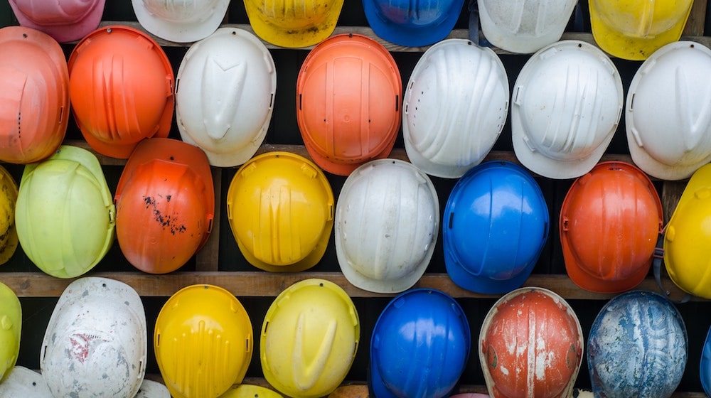 hard hats hanging on wall