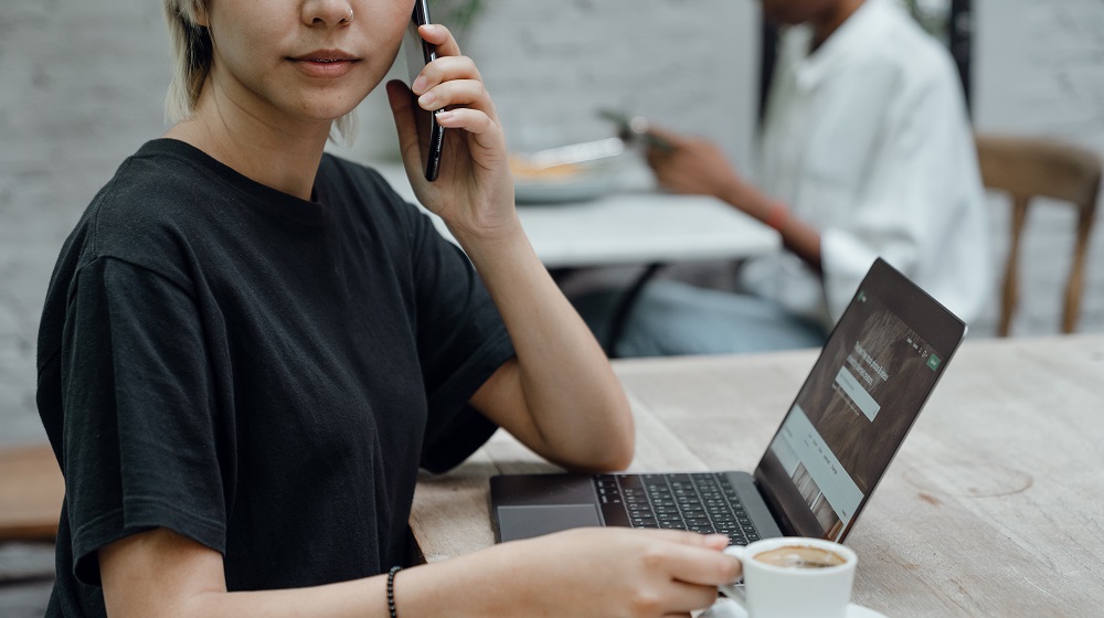 Woman on the phone drinking coffee