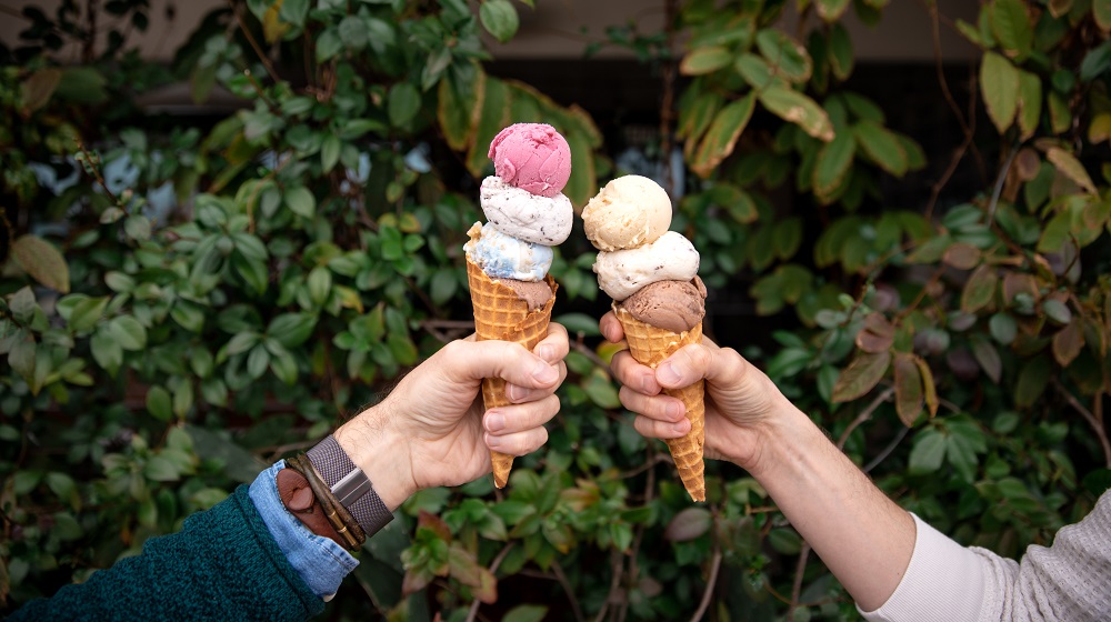 Two people holding ice cream cones