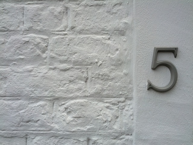 A white brick wall with the number 5 shown on the right