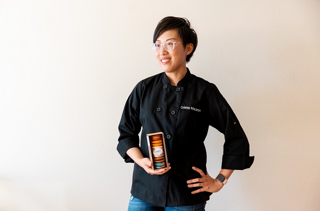 Anita Lee of Colette Macaron posing with cookies in a box