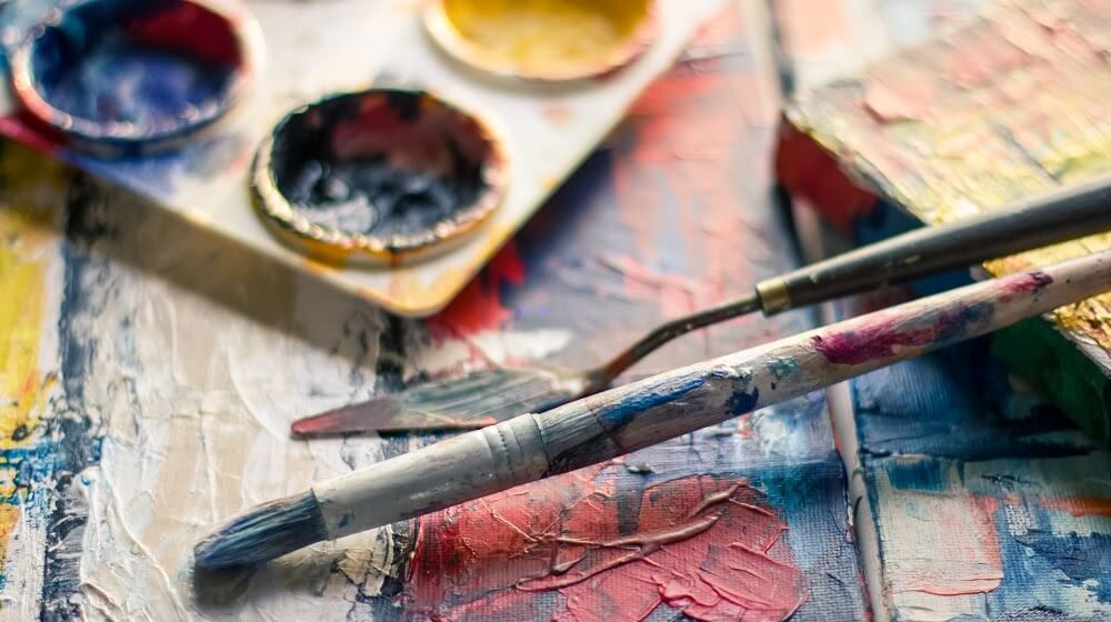 Paintbrushes resting on work surface