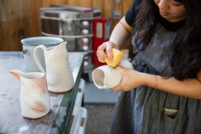 Linda Hsiao working on ceramic pitchers