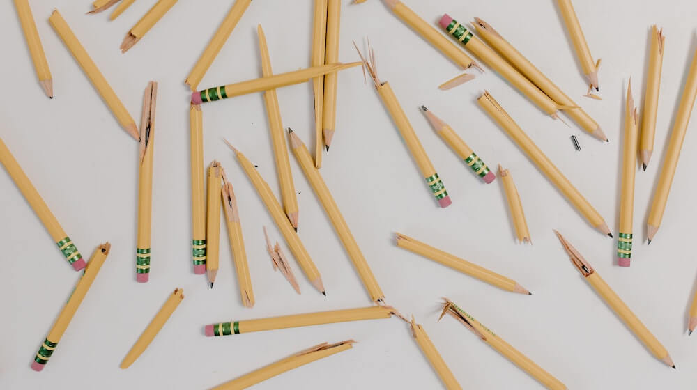 Broken pencils on a white background