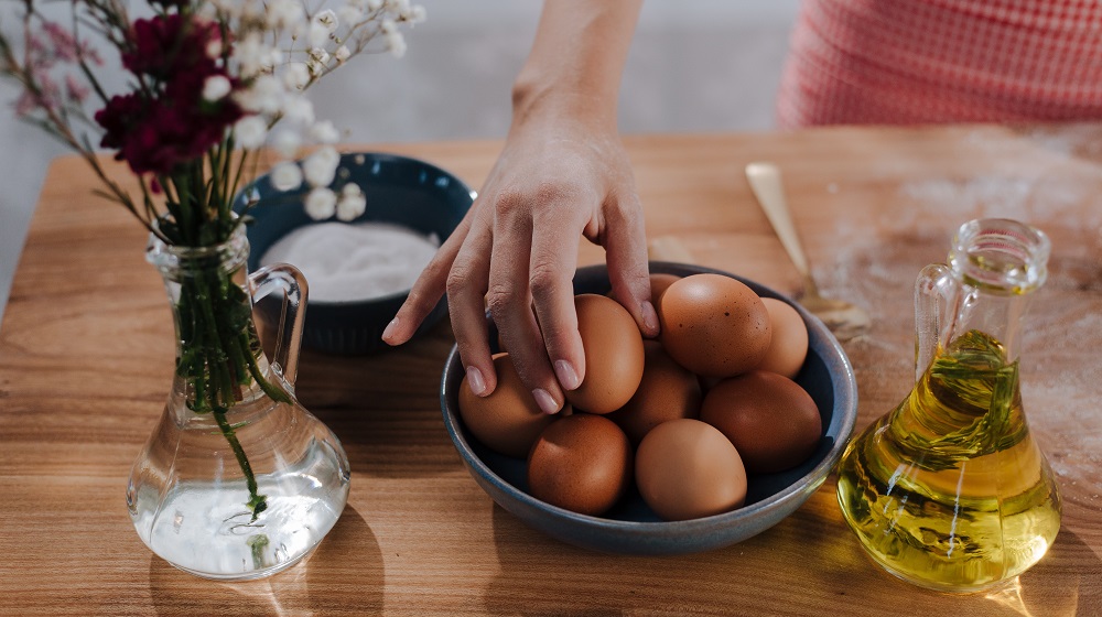 Baker reaching for eggs